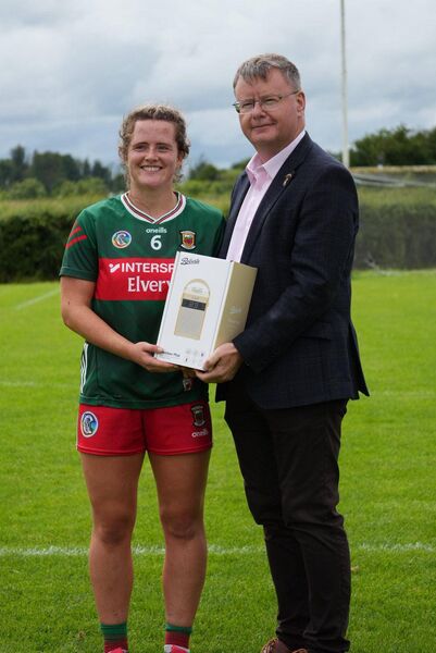 Ava Lambert is presented with the Player of the Match award by Brian Molloy, Uachtarán of the Camogie Association, following Mayo's semi-final win against Louth. Ava Lambert is presented with the Player of the Match award by Brian Molloy, Uachtarán of the Camogie Association, following Mayo's semi-final win against Louth.