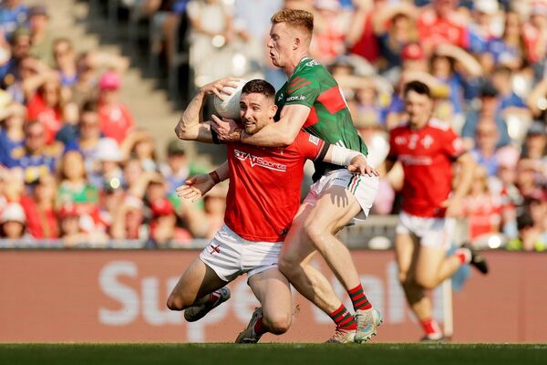 Louth's Ciaran Downey is tackled by David McBrien of Mayo. Louth's Ciaran Downey is tackled by David McBrien of Mayo.