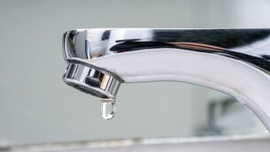 <p>Drop of water falling from faucet.</p>
