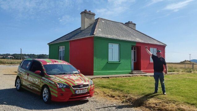 <p>Belmullet man John Shevlin, known for driving the famous ‘Up Mayo’ green and red Ford Focus, is painting his house in the county colours for the week that’s in it.</p>