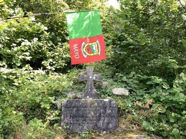 George Moore, the famous novelist, at rest in Castle Island, Lough Carra, somehow managed to source a Mayo Flag, before Mayo’s big day in Croke Park at the weekend. Picture: Tom Quinn