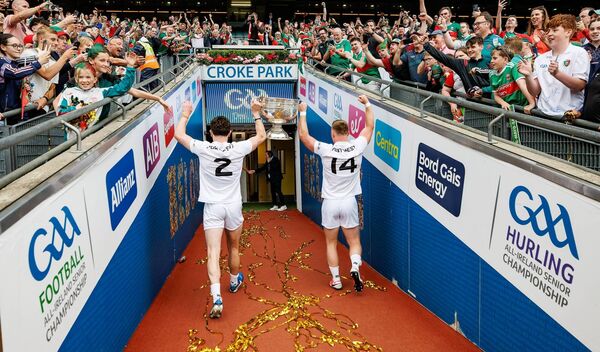 Mayo's Jack Coyne and Ryan O'Donoghue take the Sam Maguire Cup into the tunnel as Mayo fans celebrate. 	Picture: INPHO/James Crombie