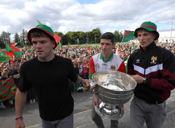 Mayo’s and Crossmolina’s Jordan Flynn, Conor Loftus and Kobe McDonald carry the Sam Maguire Cup to the presentation area at the Mayo team’s homecoming in St Tiernan’s GAA Park, Crossmolina. 	 Picture: David Farrell Photography 