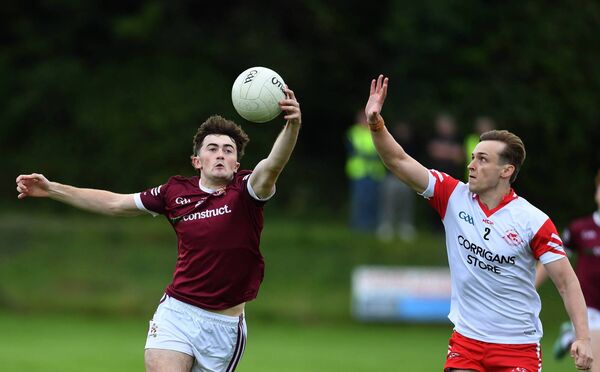 Niall Coggins of Crossmolina is first to the ball ahead of Ballintubber’s Jack Walsh. Picture: David Farrell Photography