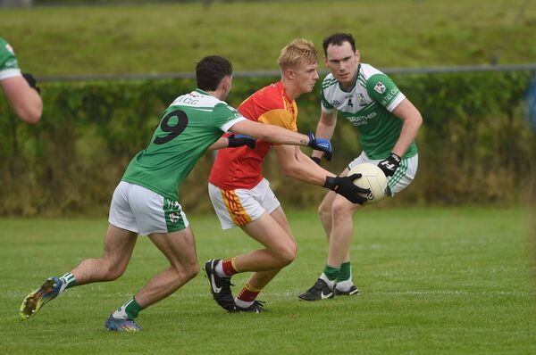 Ben Joyce of Castlebar Mitchels looks to gets a pass away despite the close of attention of The Neale defenders. Picture: Conor McKeown