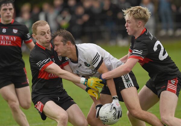 Swinford's Jason McLoughlin and Gavin Tuffy double up to try and turnover Tourmakeady's Michael Joyce. Picture: Conor McKeown Swinford's Jason McLoughlin and Gavin Tuffy double up to try and turnover Tourmakeady's Michael Joyce. Picture: Conor McKeown