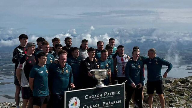 <p>Mayo team and management pictured with Sam Maguire at the top of Croagh Patrick today. Pic: Tuam Archdiocese</p>
