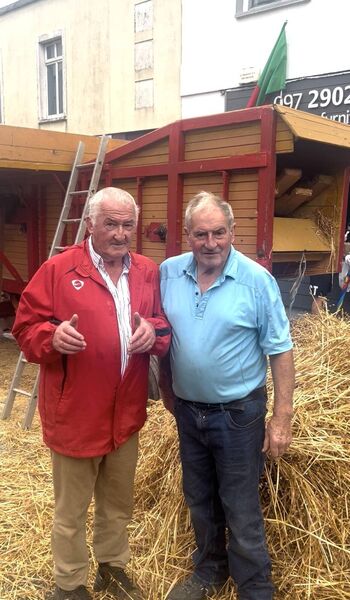 Tom Ryan (L) and Michael McLoughlin (R) with their thresher machine in the background. Tom Ryan (L) and Michael McLoughlin (R) with their thresher machine in the background.