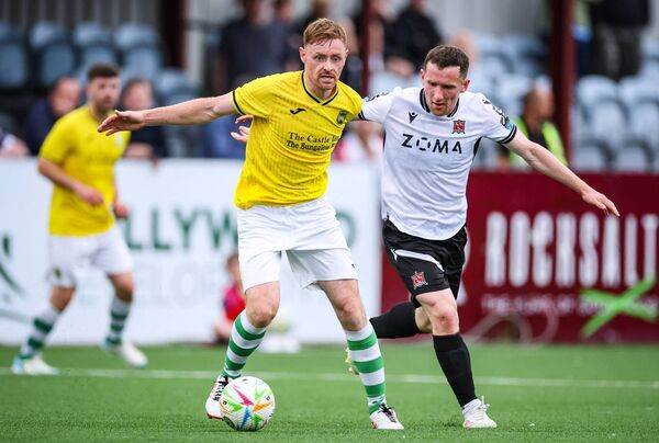 Dundalk FC's Bobby Burns tackles Niall Brennan of Castlebar Celtic during the Club Orange FAI Cup third round tie in Oriel Park. Picture: INPHO/Dan Clohessy