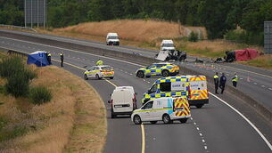 Garda charged with soliciting murder of woman and three children