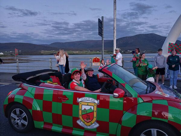 Seán Paul McNamara (driving) and Packie McGinty lead the procession onto Achill Island.