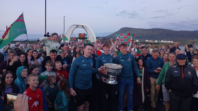 <p>All-Ireland champions Diarmuid O'Connor, Jack Carney and Donnacha McHugh pictured after carrying Sam Maguire onto Achill Island on Sunday evening. Carney played the drums on the way across.</p>