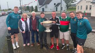 <p>Frank and Rory Courell pictured with the Sam Maguire Cup, family members and Mayo GAA manager Andy Moran and players David McBrien and Kuba Callaghan</p> <p>Frank and Rory Courell pictured with the Sam Maguire Cup, family members and Mayo GAA manager Andy Moran and players David McBrien and Kuba Callaghan</p>