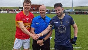 <p>Castlebar Mitchels captain John MacMonagle and his Aghamore counterpart Conor Hunt with match referee James Regan. </p> <p>Castlebar Mitchels captain John MacMonagle and his Aghamore counterpart Conor Hunt with match referee James Regan. </p>