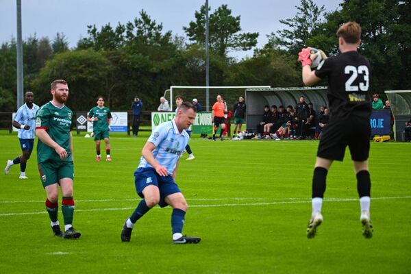 Salthill Devon goalkeeper Sam Begley collects from Mayo striker Connor McCarthy. Picture: John Corless
