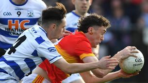 <p>Castlebar Mitchels Ultan O’Reilly holds onto the ball despite the close attention of Breaffy’s Conor Coghill at Fr O’Hara Park, Charlestown, last Saturday afternoon.	Pictures: David Farrell Photography </p>