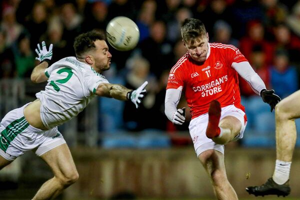 No boot? No problem: Cillian O'Connor kicks a point for Ballintubber despite the pressure of David Drake and the loss of his footwear. PIctures: INPHO/Bryan Keane