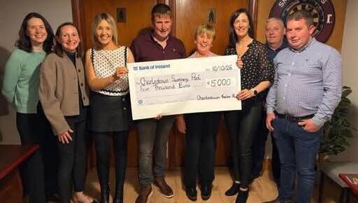 The McLoughlin family and committee members of the Eugene McLoughlin Annual Tractor Run presenting a cheque for €5000 to the Charlestown Swimming Pool committee. 