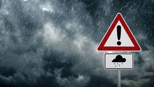 <p>A dark cloudy sky with rain and warning sign - computer generated image. Pic: iStock</p>